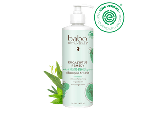 Babo Botanicals Eucalyptus Remedy shampoo & wash bottle with green leaves on a black background