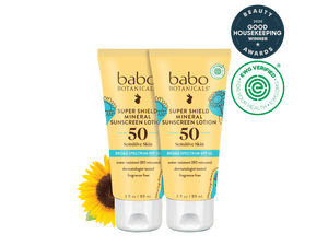 Two tubes of Babo Botanicals Super Shield Mineral Sunscreen Lotion on a black background with a sunflower and awards logo.