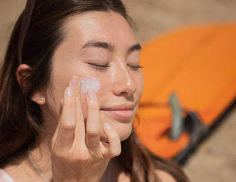 Young girl applying stick sunscreen