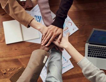 group of hands in a circle 