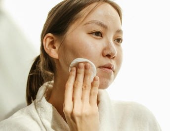 Woman applying miracle cream on face