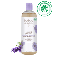 Babo Botanicals Calming Lavender Bubble Bath & Wash bottle with lavender flowers on a black background