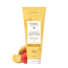 A tube of babo Botanicals Mango & Hibiscus Nourishing Conditioner, shown on a white background with a mango and hibiscus flower graphic at the bottom left.