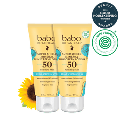Two tubes of Babo Botanicals Super Shield Mineral Sunscreen Lotion on a black background with a sunflower and awards logo.