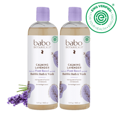 Two bottles of babo Botanicals Calming Lavender Bubble Bath & Wash on a black background with lavender flowers.