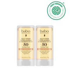 Two Babo Botanicals-Daily sheer tinted mineral sunscreen stick SPF50 duo with a sunflower on a black background, featuring an EWG Verified logo.