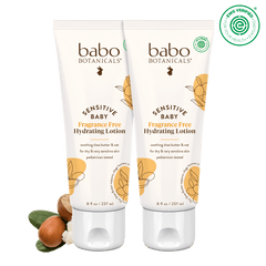 Two tubes of Babo Botanicals Sensitive Baby Hydrating Lotion on a black background